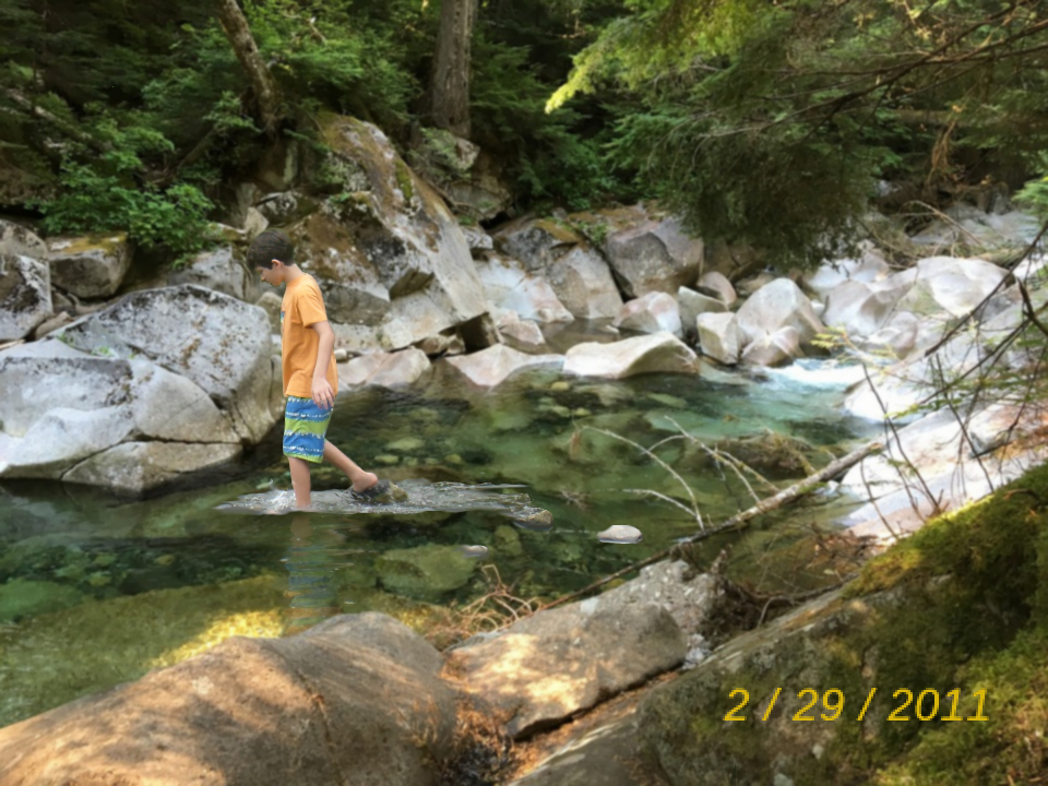 digital photo manipulation of a boy wading through a rock pool